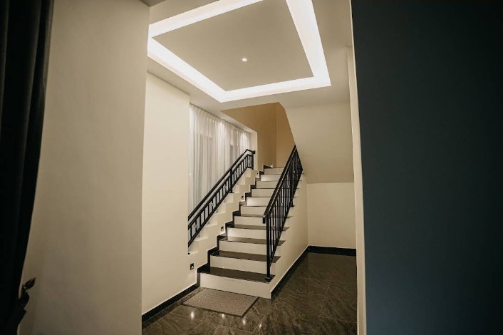 Bright modern staircase with ambient ceiling lighting